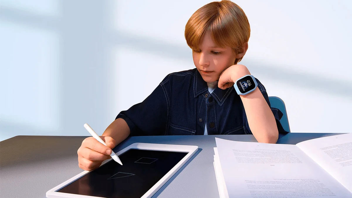 Kind draagt een Xiaomi Smart Kids Watch kinderhorloge en maakt schoolwerk op een tablet